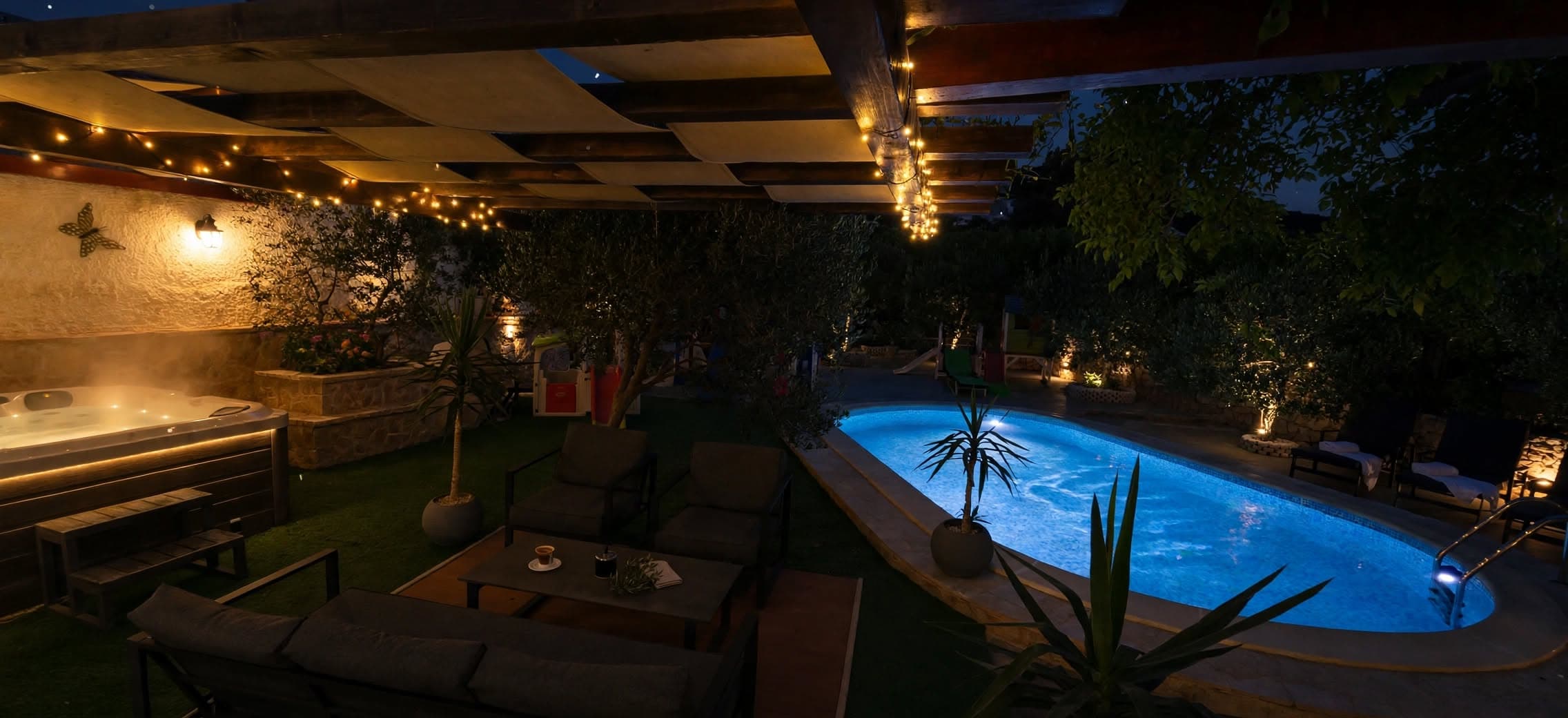The pool and hot tub lit up at night