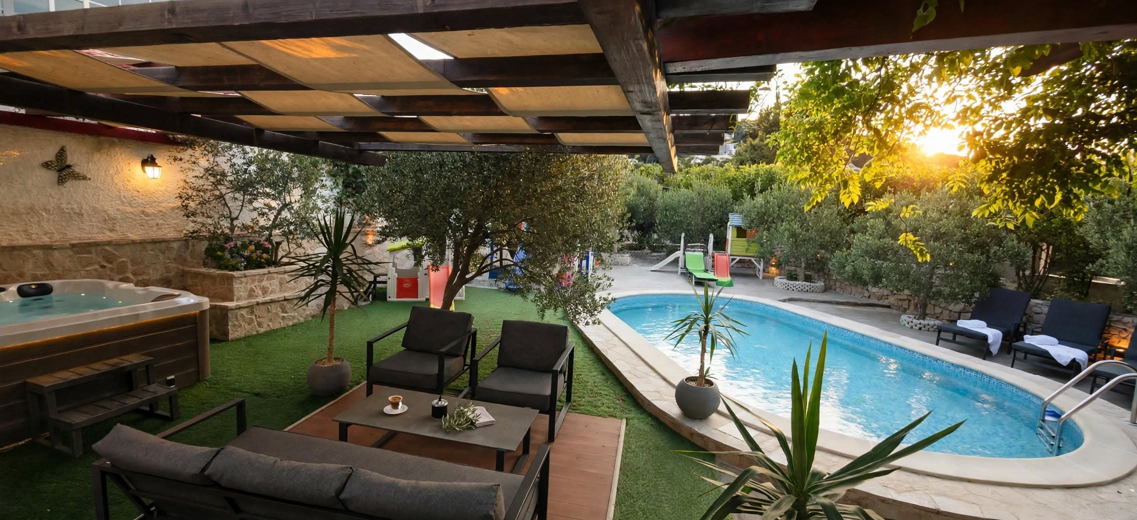 Pergola lounge next to the pool and hot tub at sunset